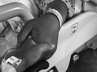 Kian Auerbach and her father holding hands.