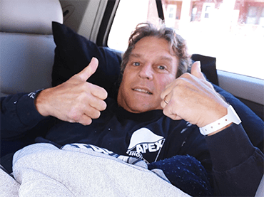 Terry Sutton gives a thumb up signal and smiles enthusiastically. He has short hair and wears a black sweatshirt. 